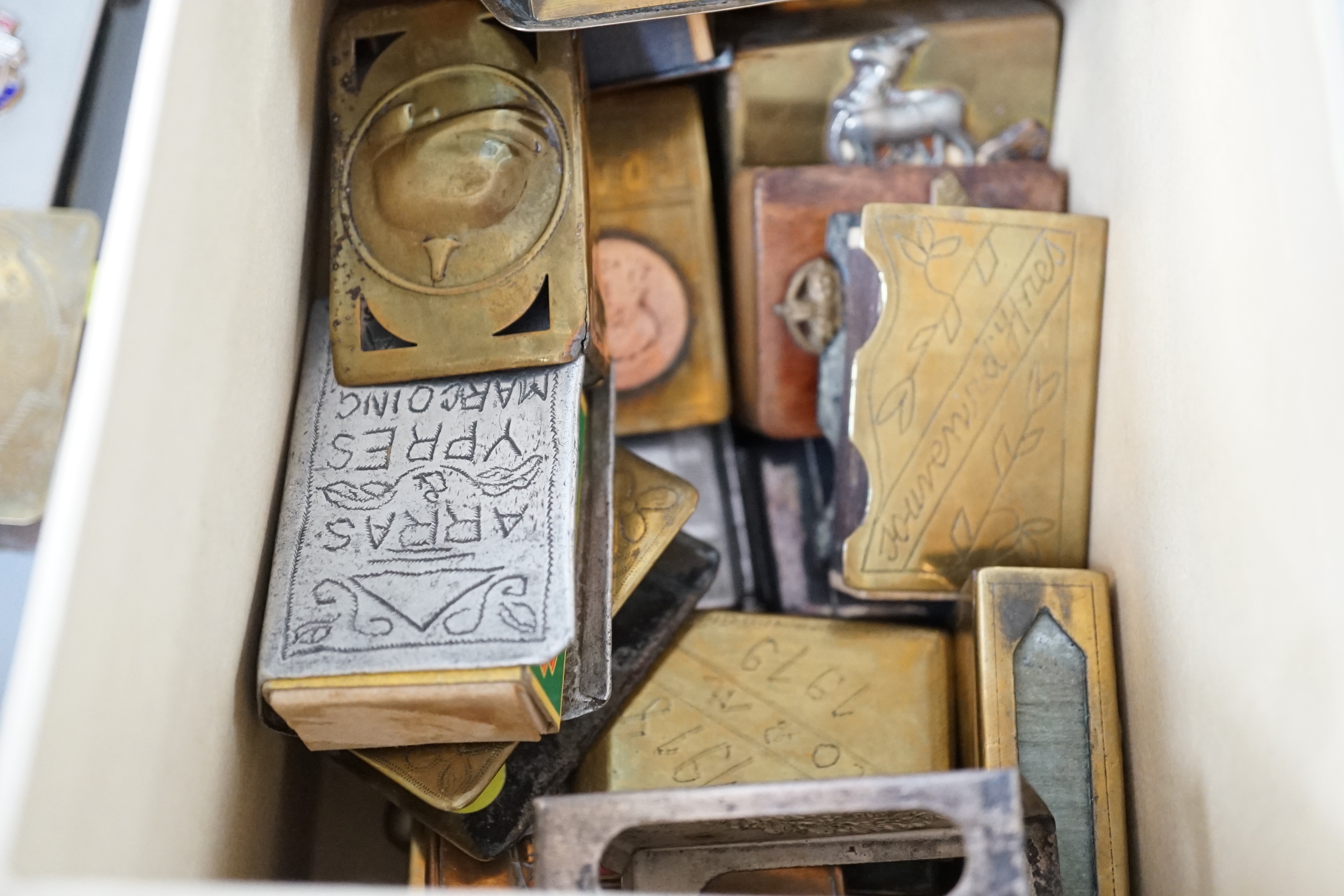 A collection of trench art and military vestas and matchbox holders